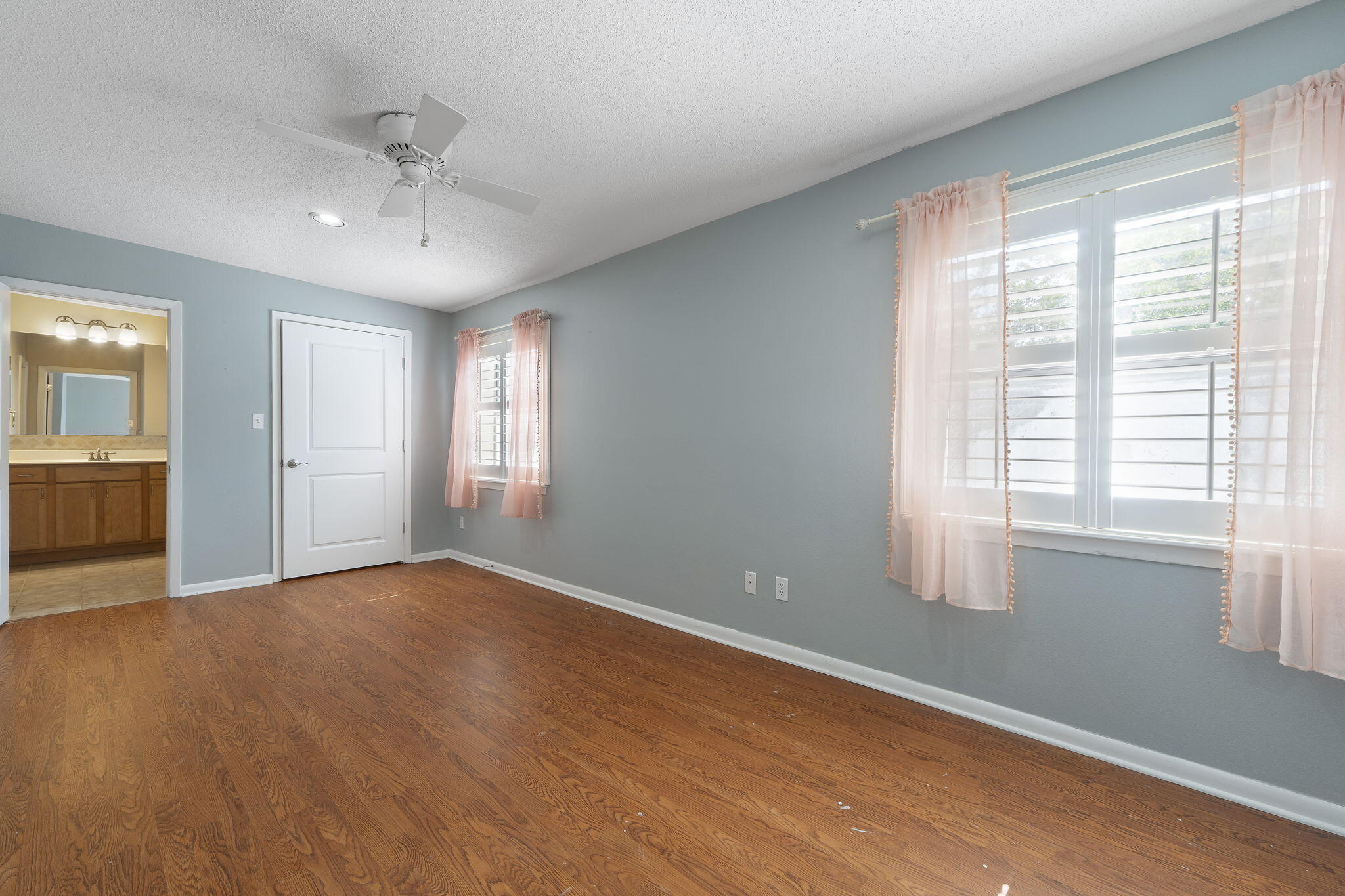 12 Hillcrest Drive Shalimar, FL 32579 - Photo 25 of 45 a view of an empty room with a window and wooden floor