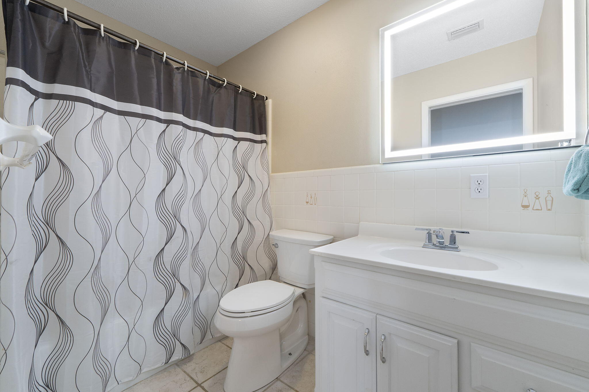 12 Hillcrest Drive Shalimar, FL 32579 - Photo 29 of 45 a bathroom with a sink and mirror with toilet