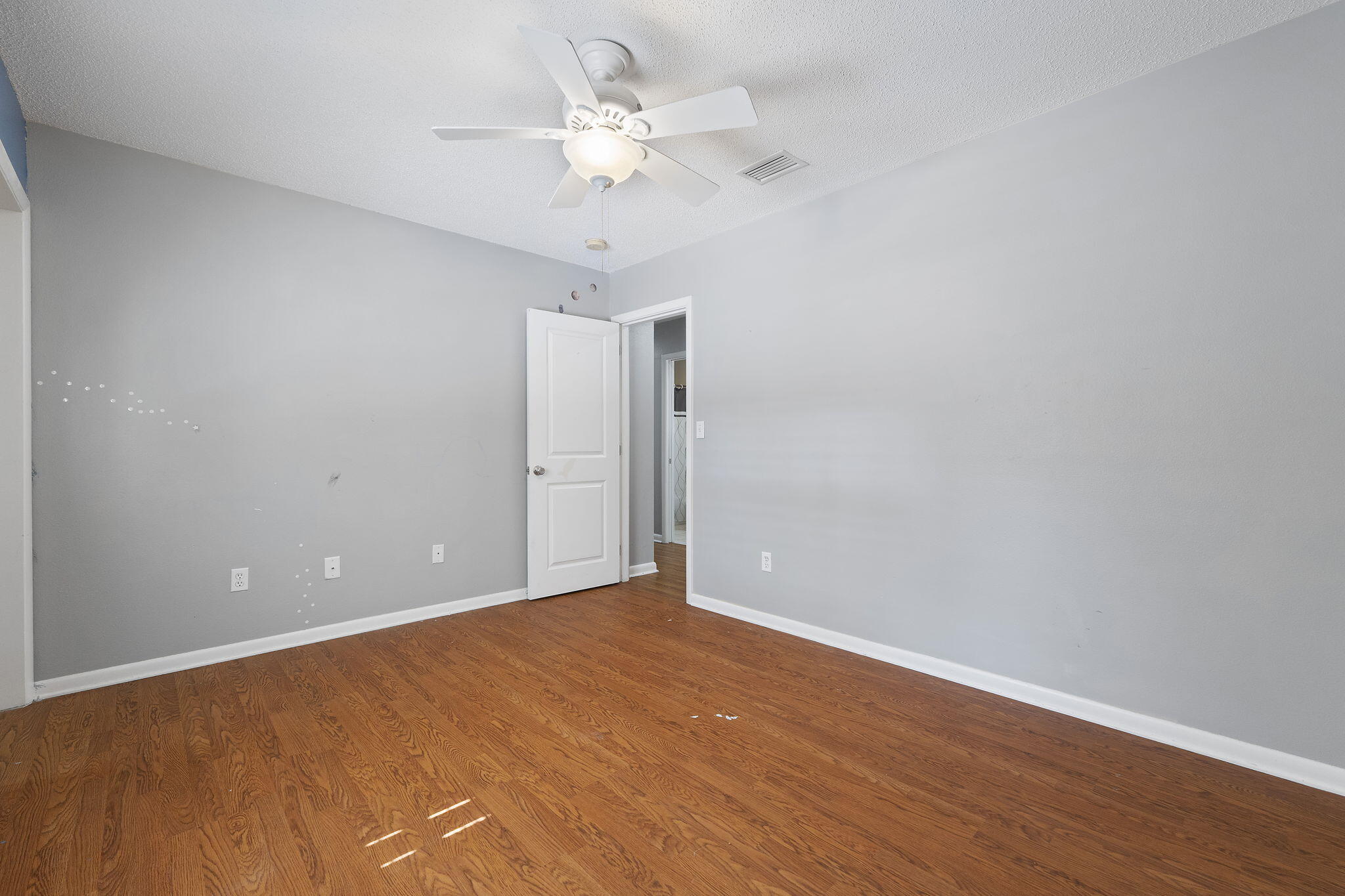 12 Hillcrest Drive Shalimar, FL 32579 - Photo 35 of 45 a view of an empty room with a chandelier fan