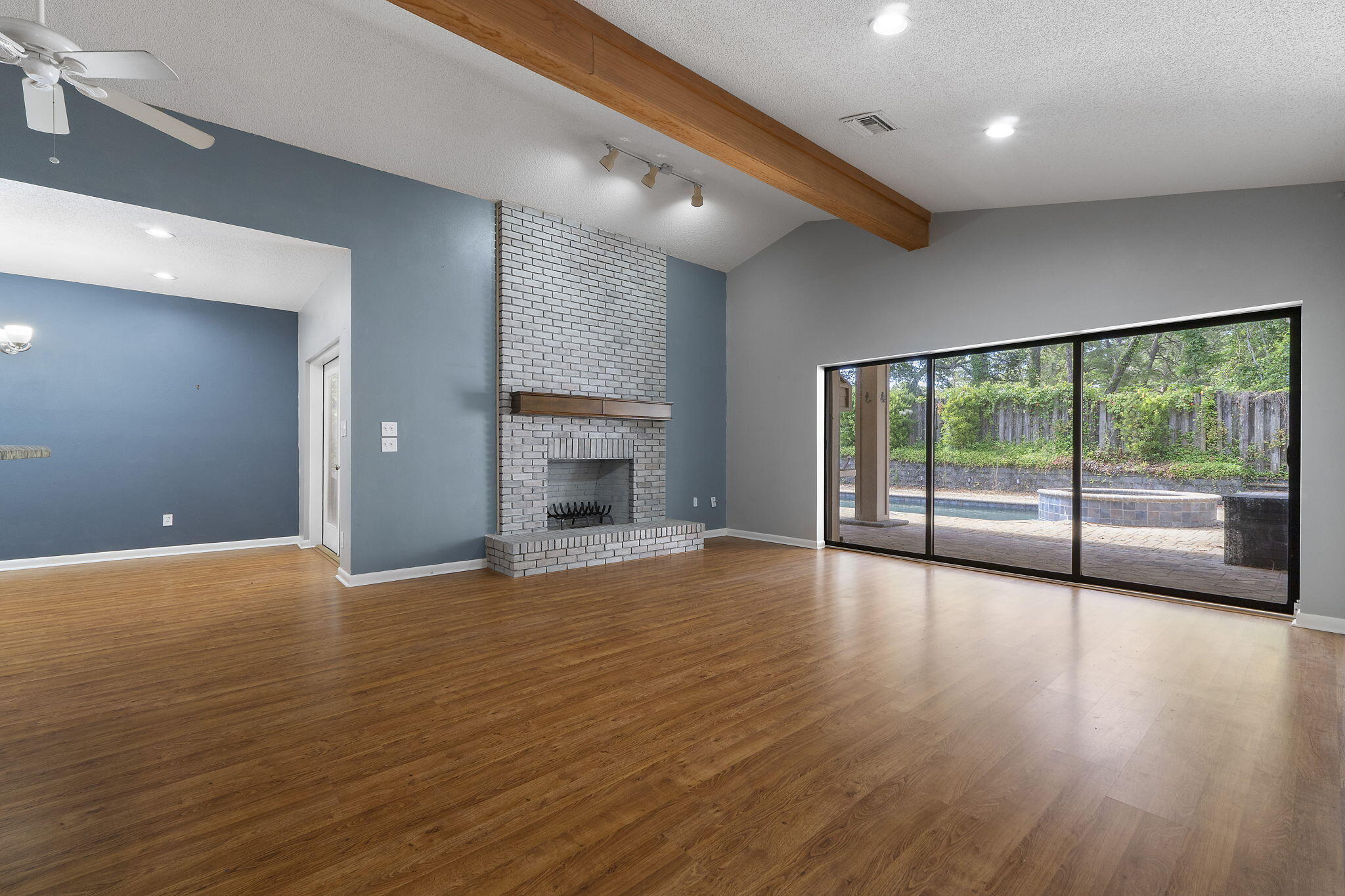 12 Hillcrest Drive Shalimar, FL 32579 - Photo 6 of 45 a view of empty room with wooden floor and fireplace