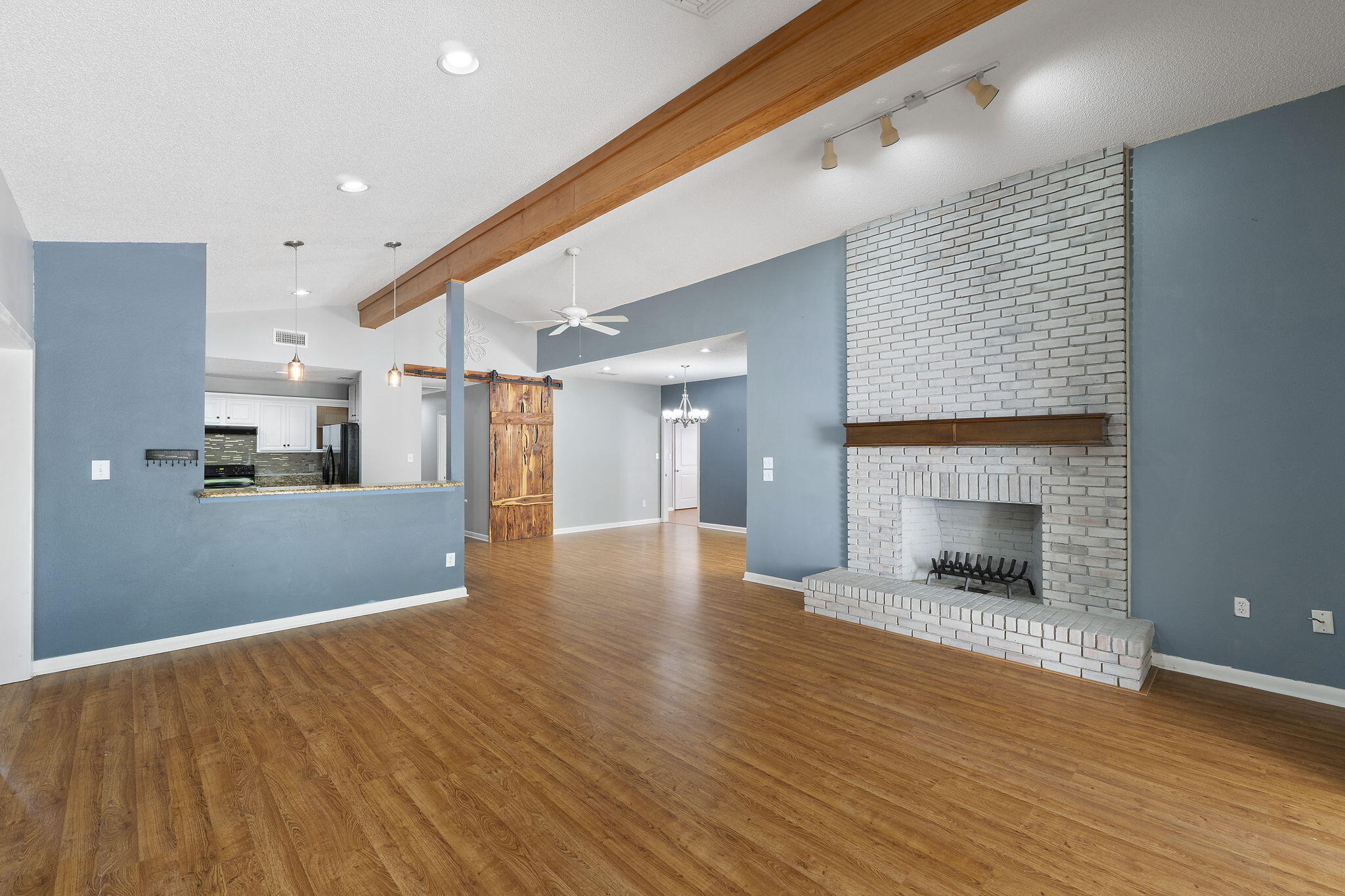 12 Hillcrest Drive Shalimar, FL 32579 - Photo 7 of 45 a view of a kitchen with a fridge and wooden floor