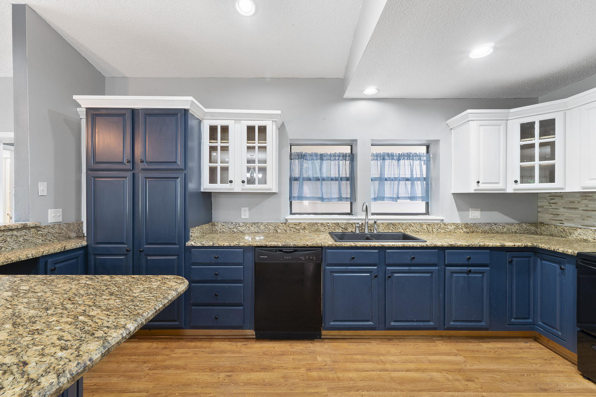 12 Hillcrest Drive Shalimar, FL 32579 - Photo 8 of 45 a large kitchen with kitchen island granite countertop wooden cabinets a sink and dishwasher