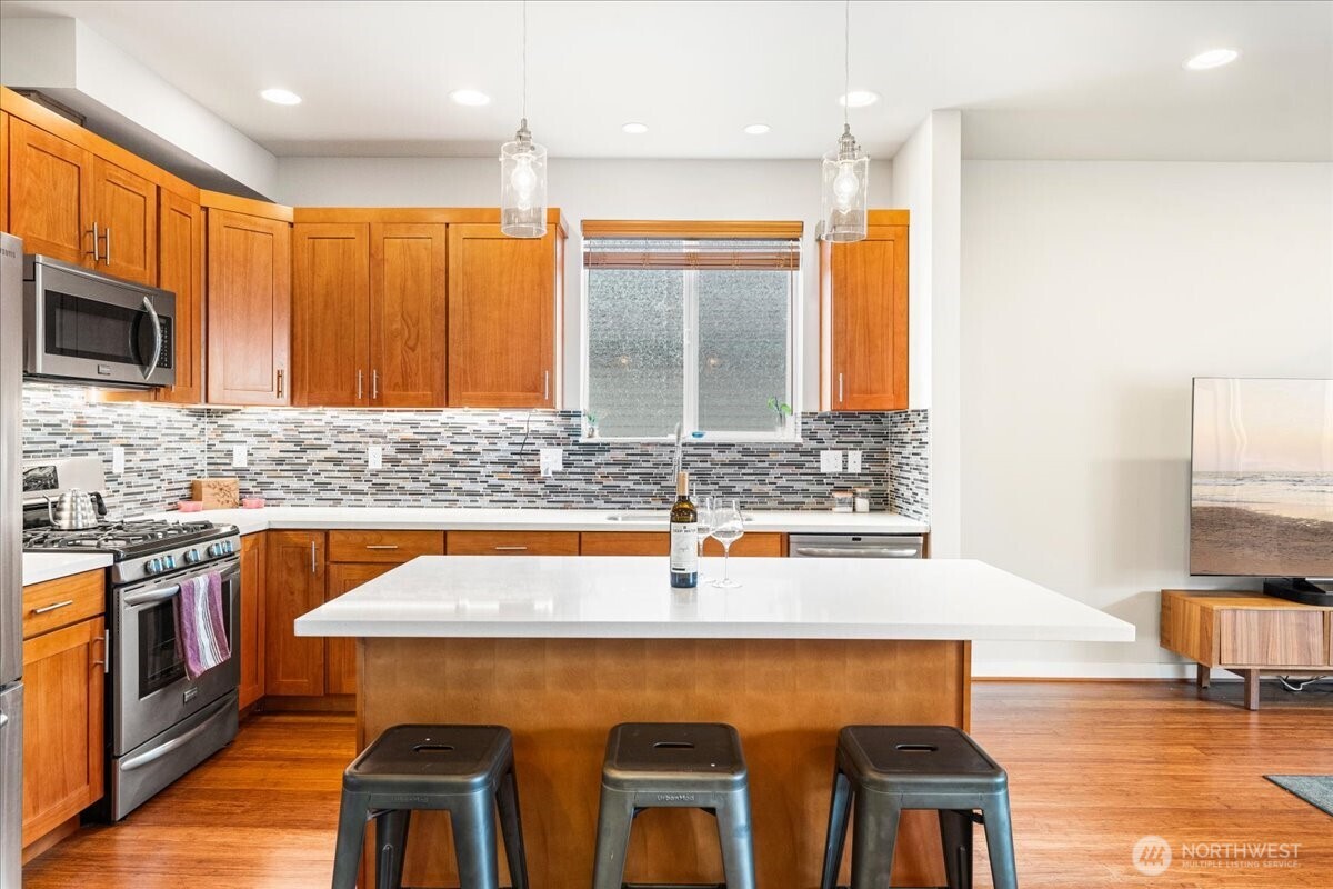 12418 2nd Place Southwest Burien, WA 98146 - Photo 6 of 39 a kitchen with stainless steel appliances granite countertop a sink and a microwave
