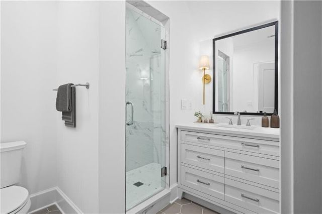 a bathroom with a shower a sink and a mirror