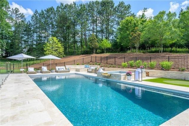 a view of a swimming pool with a lounge chair