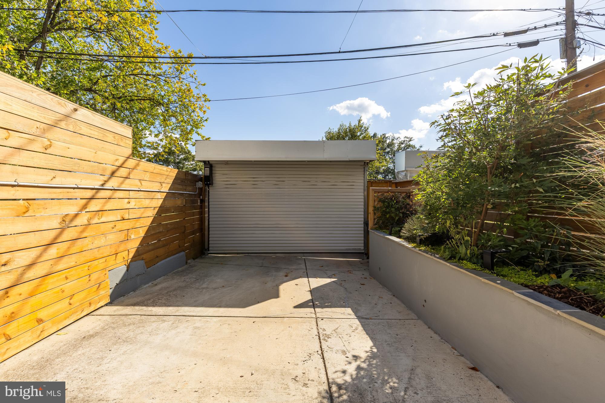 47 T Street Northeast Washington, DC 20002 - Photo 23 of 45 Modern garage entrance with lush greenery