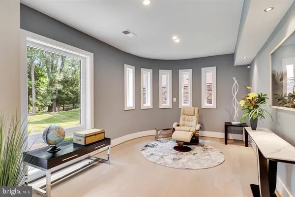 a living room with furniture and a dining table with kitchen view
