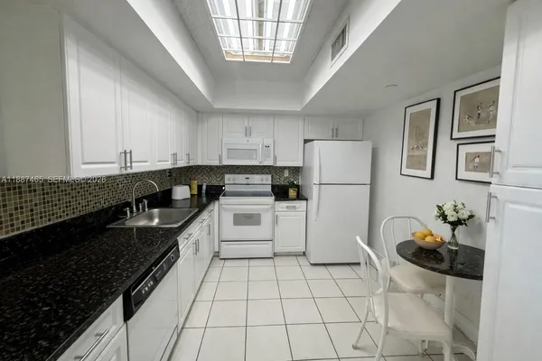 a kitchen with a sink a stove and refrigerator
