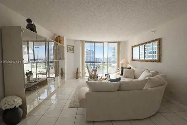 a living room with furniture and large windows