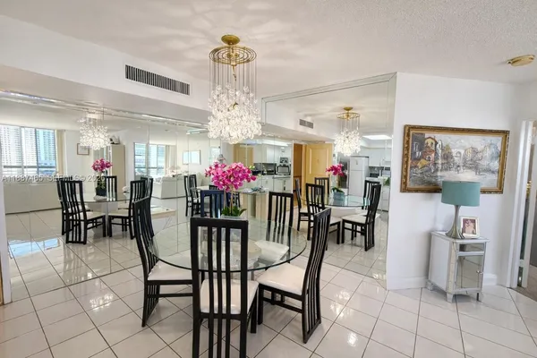 a view of a dining room with furniture and chandelier