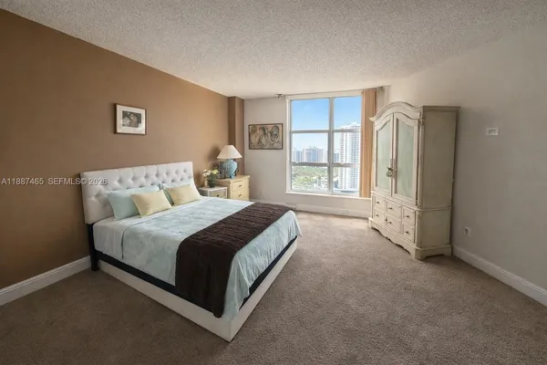 a spacious bedroom with a bed and a window