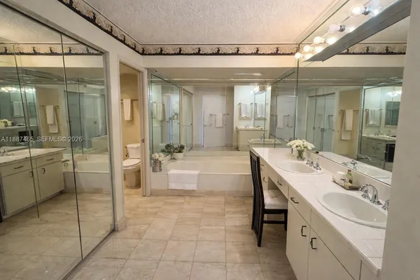 a bathroom with a sink shower and a mirror