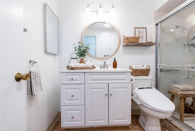 a bathroom with a toilet a sink and mirror