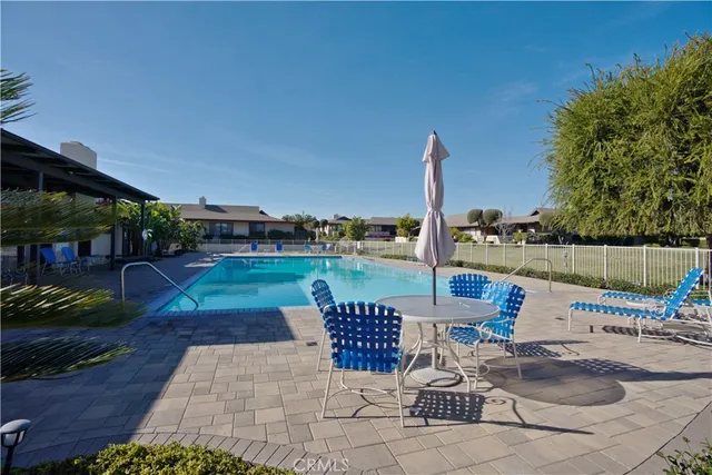 a swimming pool with outdoor seating and yard