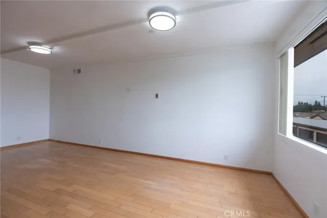 a kitchen with a refrigerator a stove a sink and a large window