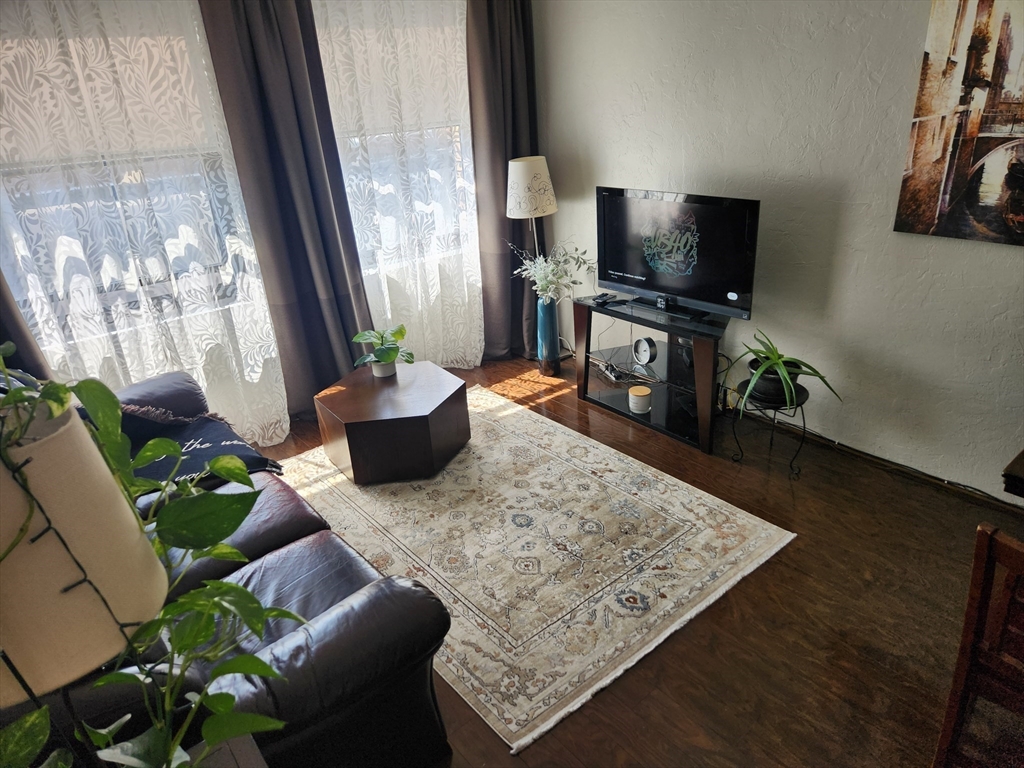 17 Federal Street, Unit 506 Worcester, MA 01608 - Photo 2 of 17 a living room with furniture and a flat screen tv