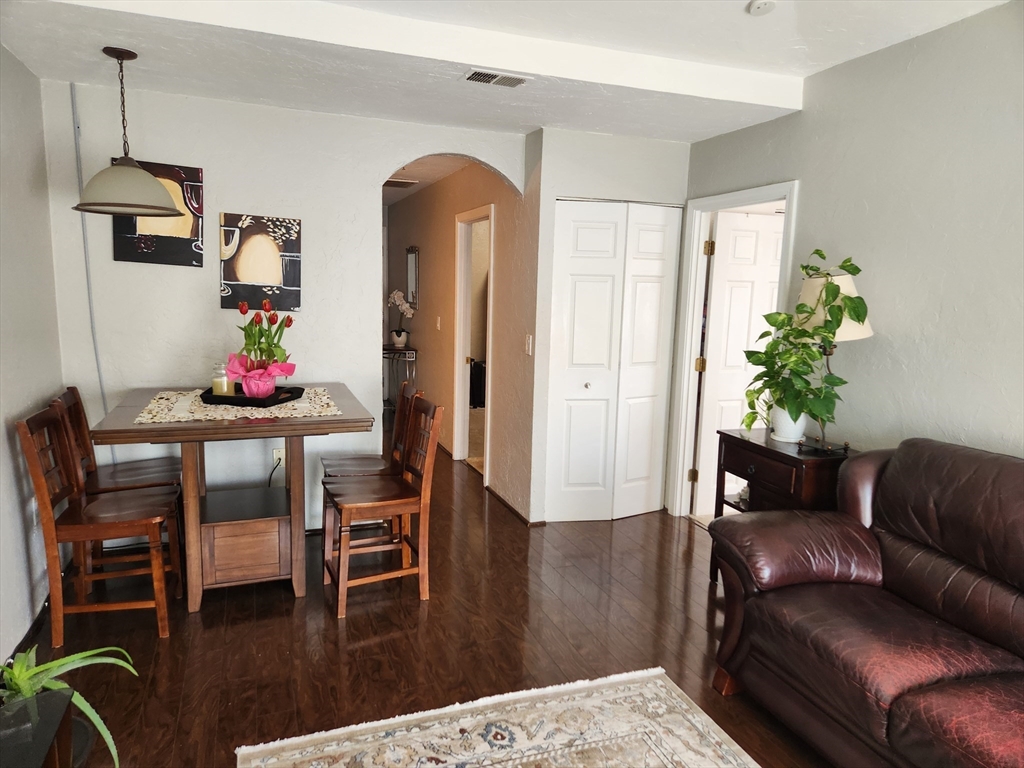 17 Federal Street, Unit 506 Worcester, MA 01608 - Photo 3 of 17 a living room with furniture and wooden floor