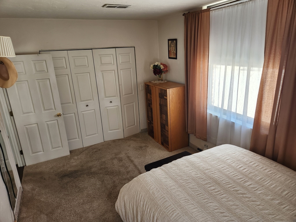 17 Federal Street, Unit 506 Worcester, MA 01608 - Photo 5 of 17 a bedroom with a bed and a window