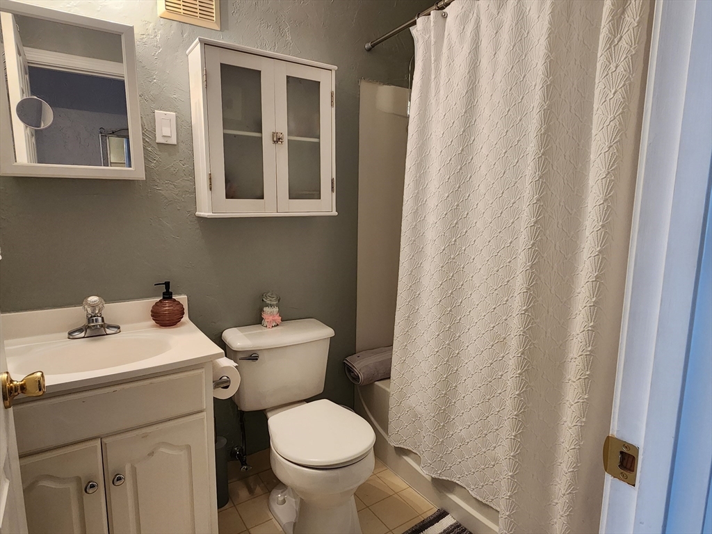 17 Federal Street, Unit 506 Worcester, MA 01608 - Photo 6 of 17 a bathroom with a sink mirror and toilet