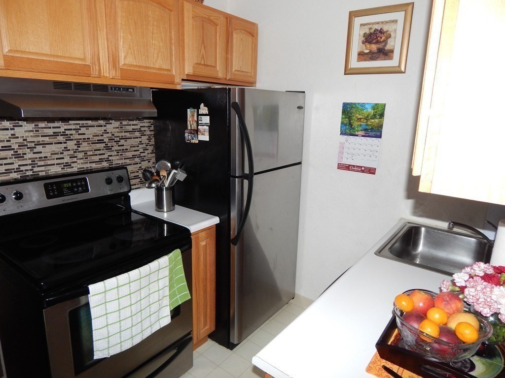 17 Federal Street, Unit 506 Worcester, MA 01608 - Photo 9 of 17 a kitchen with stainless steel appliances granite countertop a stove a refrigerator and a microwave