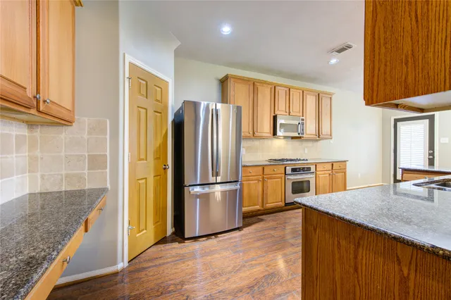 a kitchen with a refrigerator and a sink