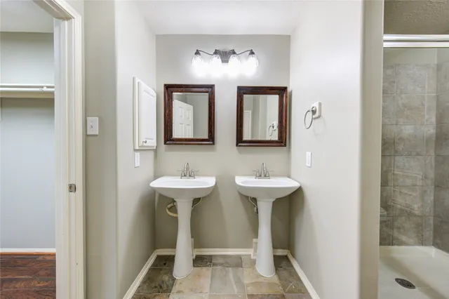 a bathroom with 2 sink and a mirror