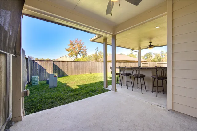 a view of a porch with chairs and backyard