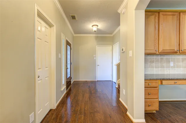 a view of a hallway with wooden floor and closet