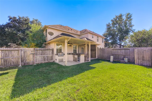 a view of a house with a yard and sitting area