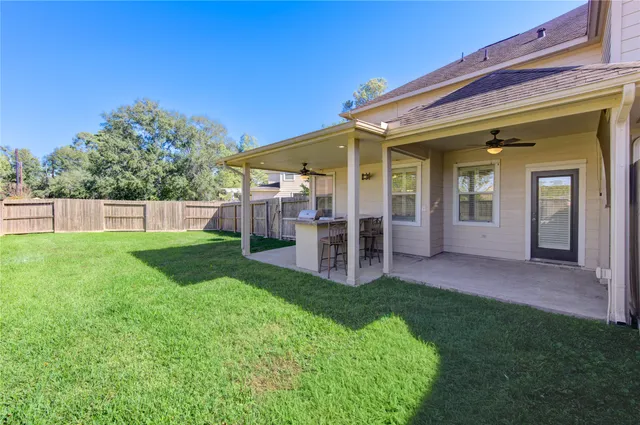 a view of a house with backyard and porch