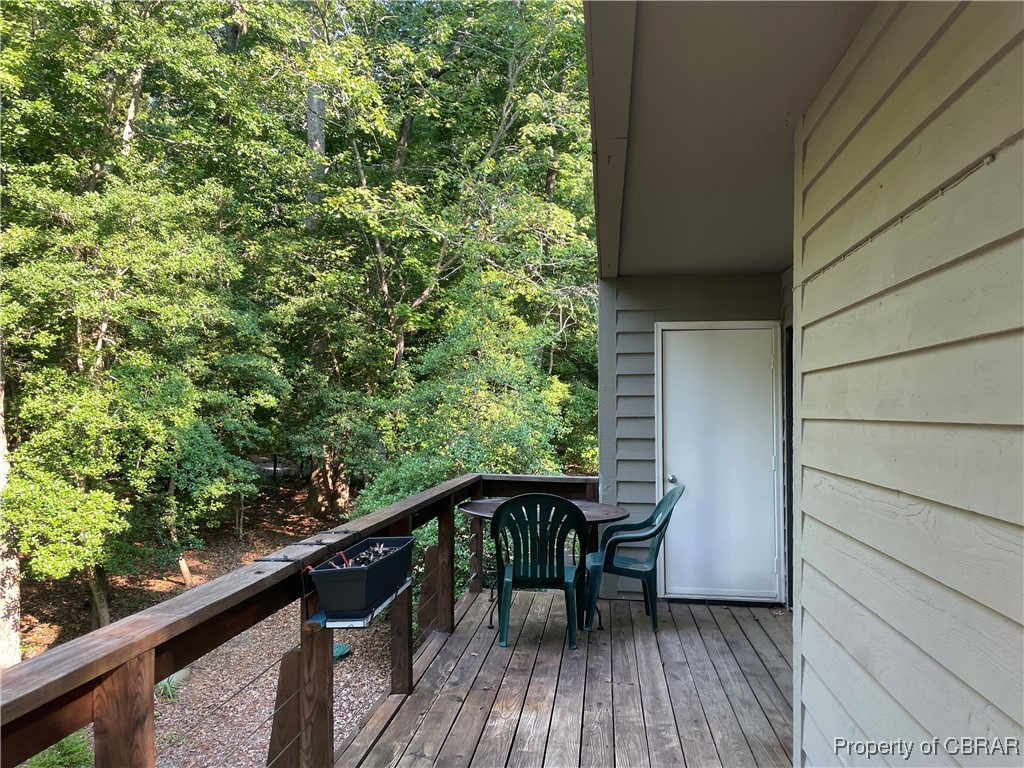 68 Villa Ridge Drive, Unit 4F Hartfield, VA 23071 - Photo 6 of 23 Wooden deck featuring a view of trees