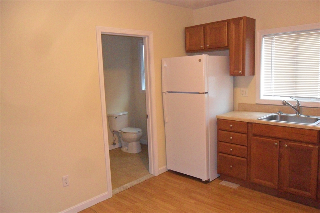 848 Waverly Street, Unit 4 Framingham, MA 01702 - Photo 12 of 14 a white refrigerator freezer sitting inside of a kitchen