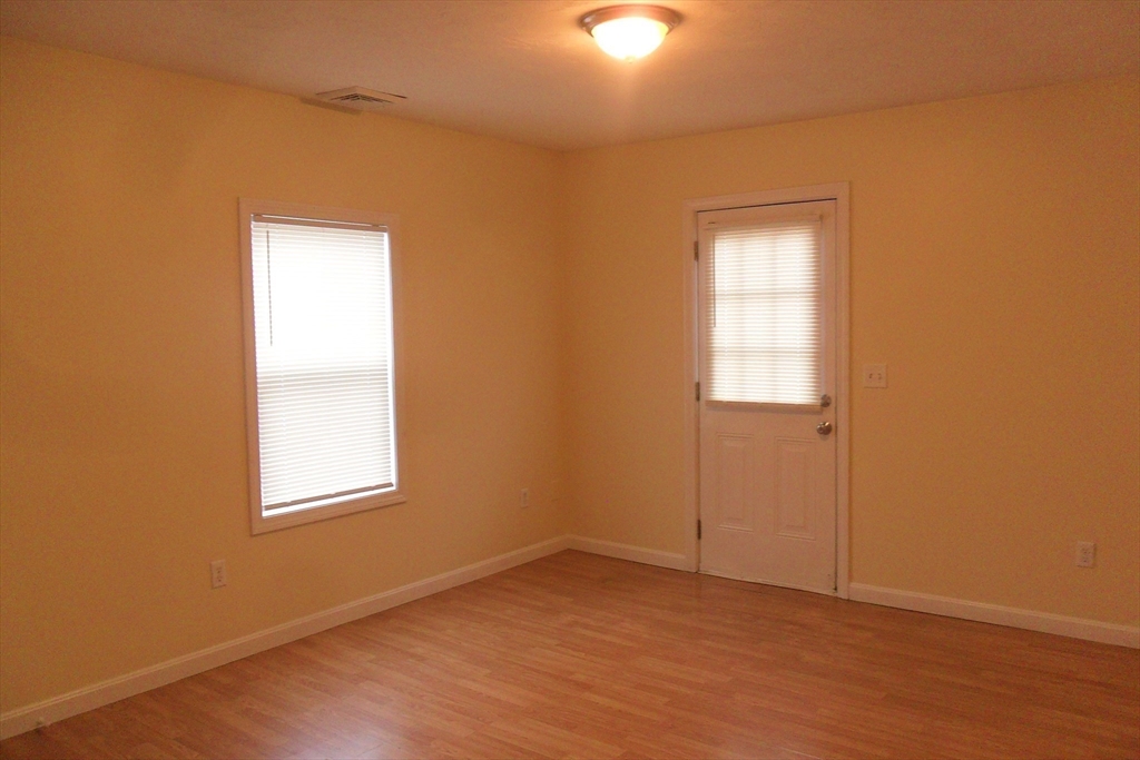 848 Waverly Street, Unit 4 Framingham, MA 01702 - Photo 10 of 14 an empty room with windows