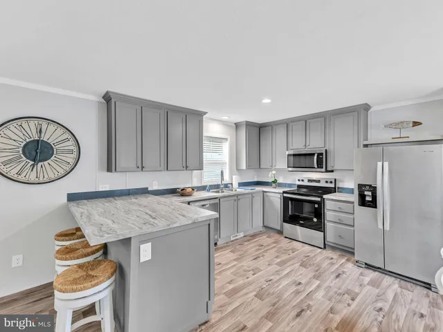 a kitchen with granite countertop cabinets sink and window