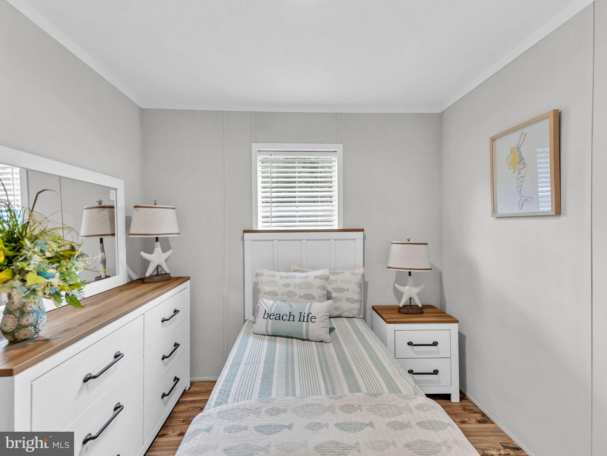 12623 Shell Mill Road, Unit 56 Bishopville, MD 21813 - Photo 29 of 73 a spacious bedroom with a bed and a potted plant