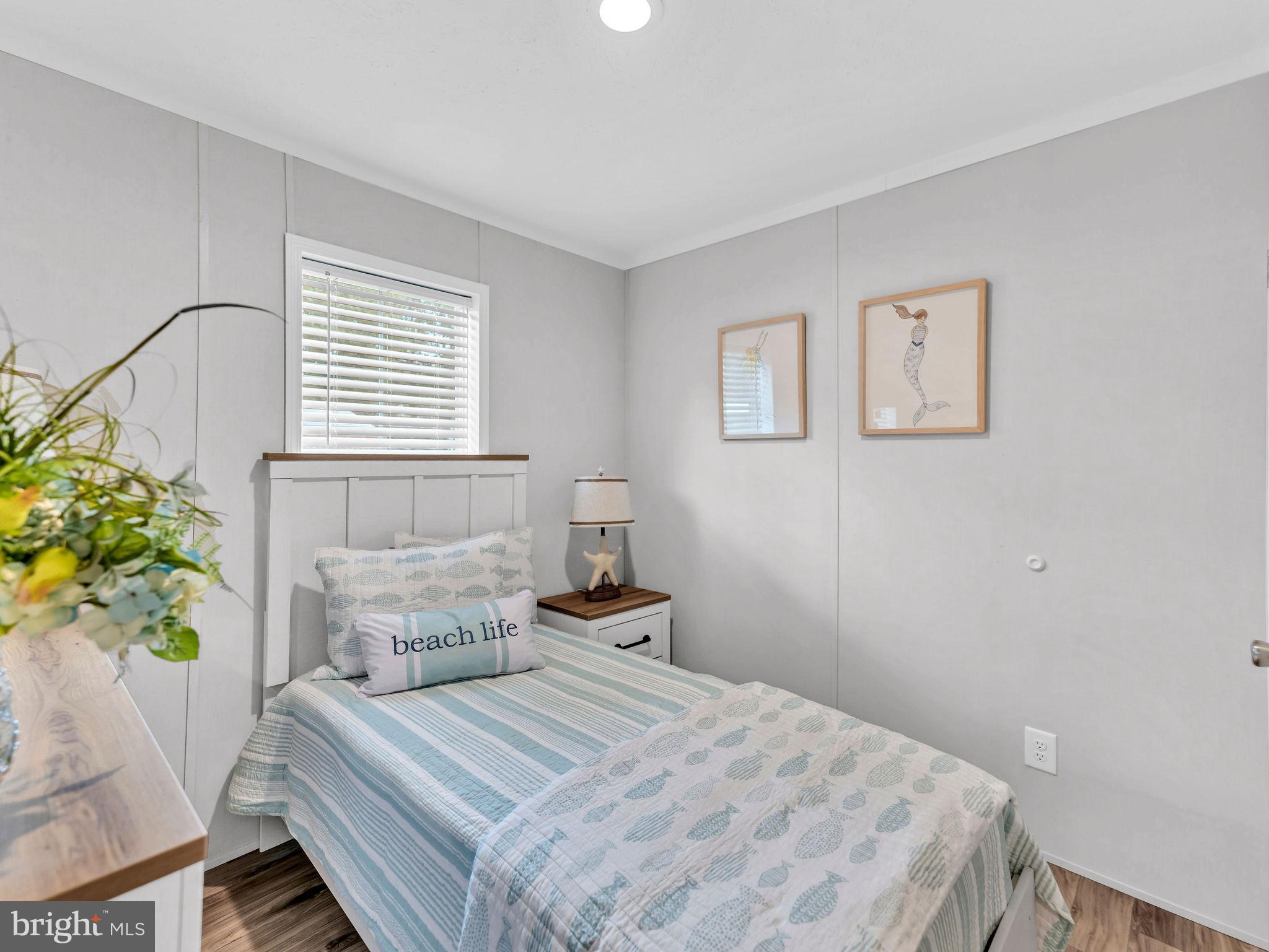 12623 Shell Mill Road, Unit 56 Bishopville, MD 21813 - Photo 31 of 73 a bedroom with a bed and a window