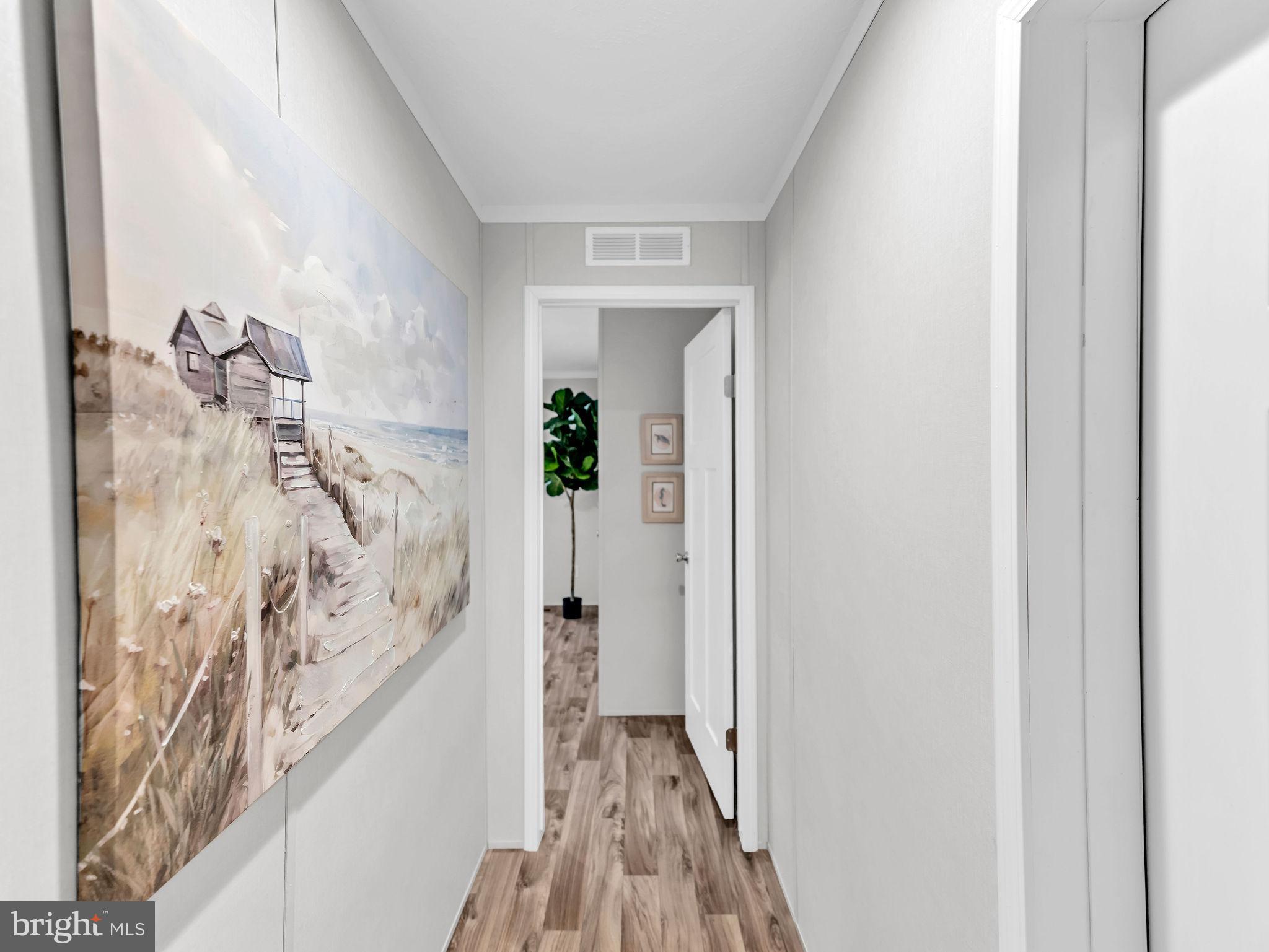 12623 Shell Mill Road, Unit 56 Bishopville, MD 21813 - Photo 32 of 73 a view of a hallway with wooden floor and staircase