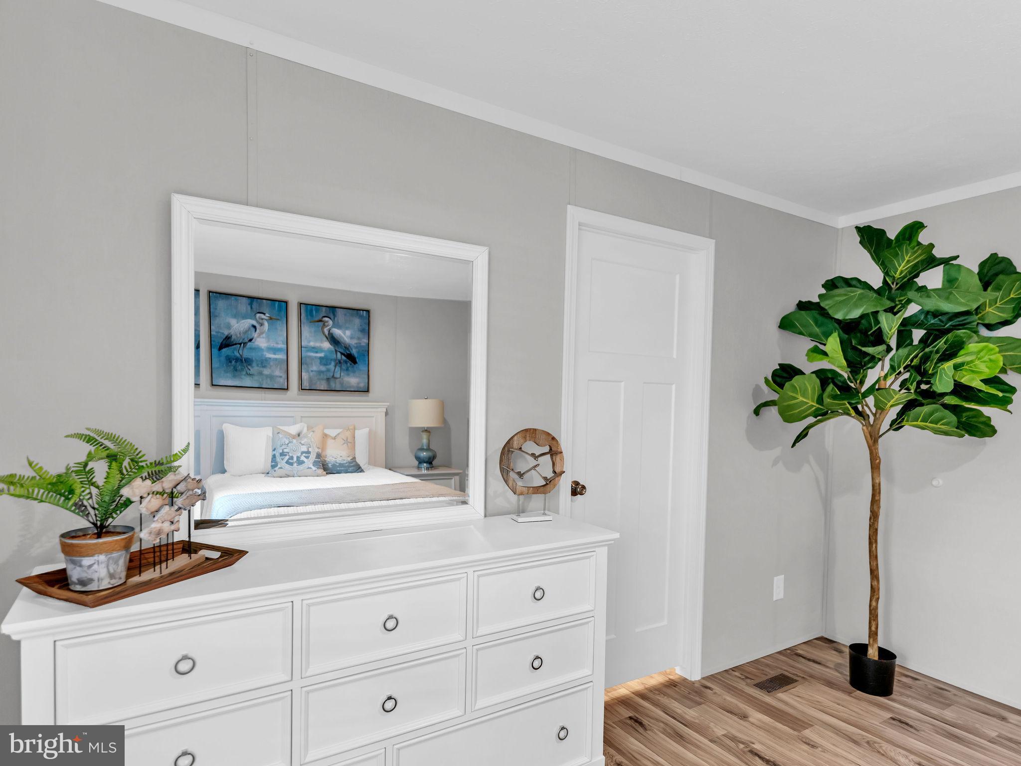 12623 Shell Mill Road, Unit 56 Bishopville, MD 21813 - Photo 40 of 73 a bathroom with a granite countertop sink a potted plant and a window