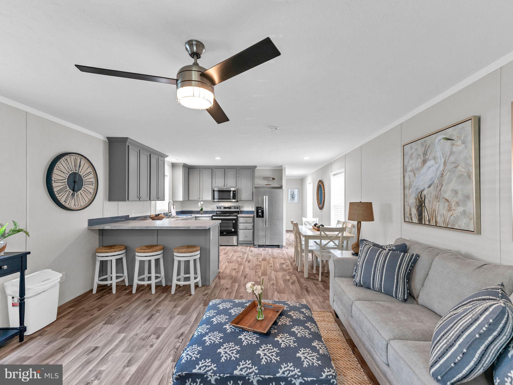 12623 Shell Mill Road, Unit 56 Bishopville, MD 21813 - Photo 55 of 73 a living room with lots of furniture and kitchen view