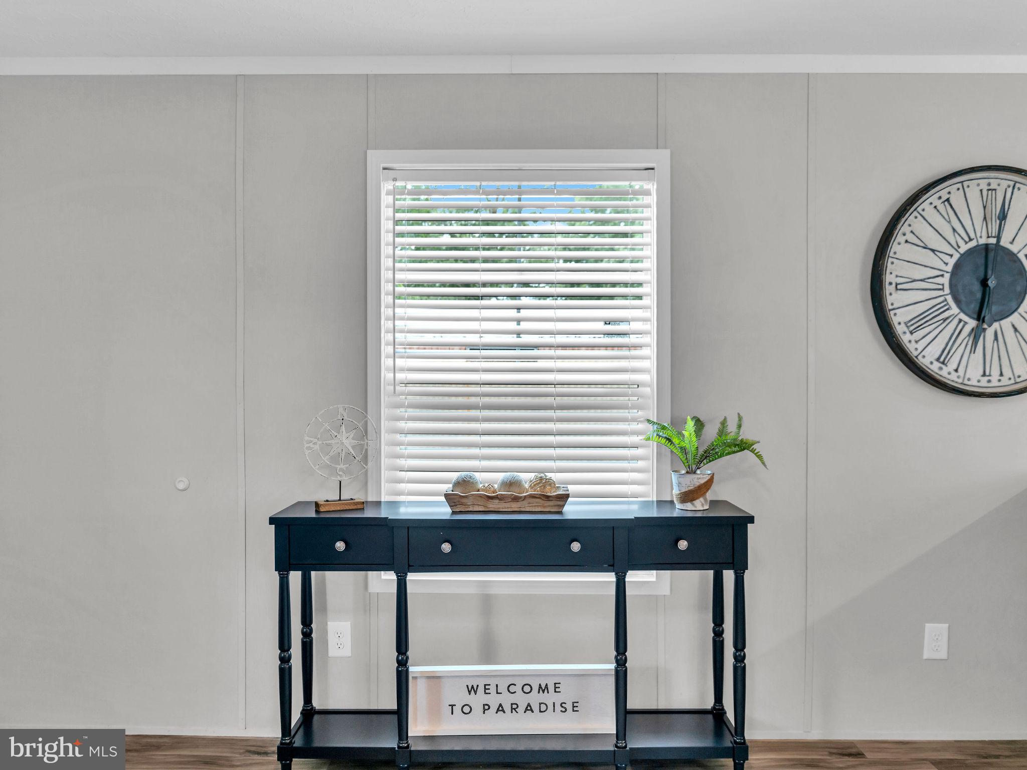 12623 Shell Mill Road, Unit 56 Bishopville, MD 21813 - Photo 6 of 73 a view of a room with a window and potted plants