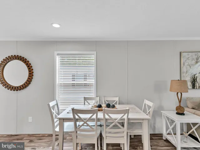 a view of a dining room with furniture and windows