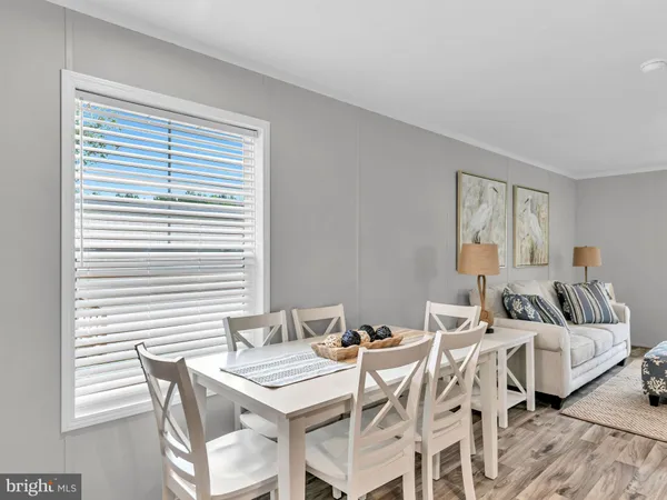 a view of a dining room with furniture and a window