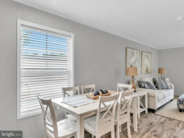 a view of a dining room with furniture and a window