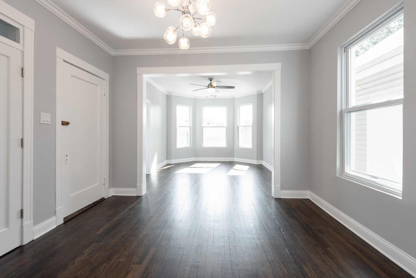 4226 North Bernard Street, Unit 2 Chicago, IL 60618 - Photo 2 of 9 a view of an empty room with wooden floor and a window
