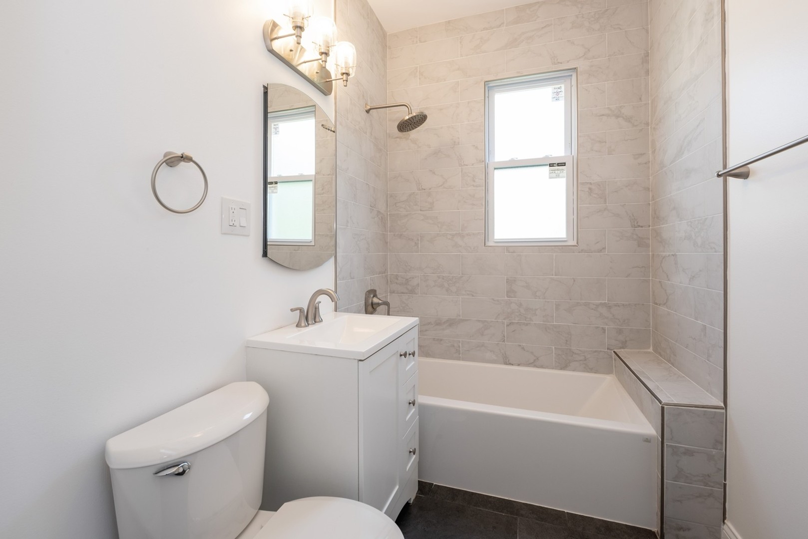 4226 North Bernard Street, Unit 2 Chicago, IL 60618 - Photo 4 of 9 a bathroom with a sink a toilet and a bathtub