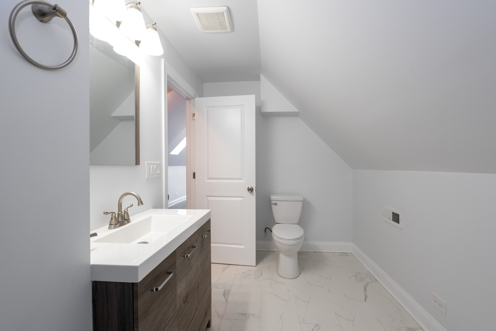 4226 North Bernard Street, Unit 2 Chicago, IL 60618 - Photo 5 of 9 a bathroom with a toilet sink and mirror