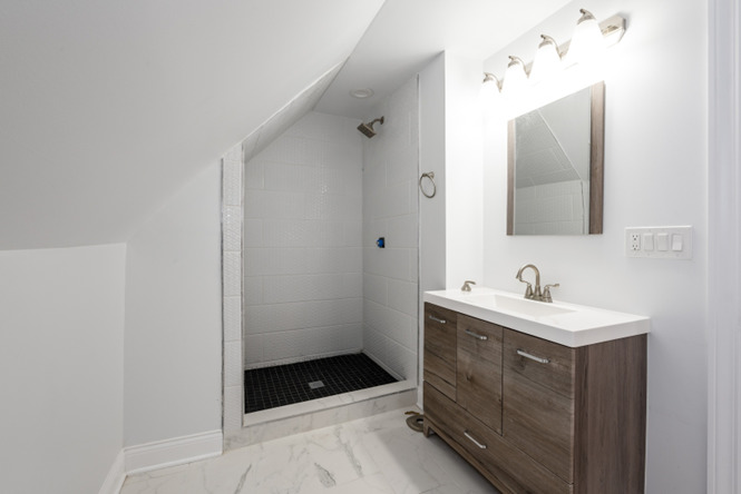 4226 North Bernard Street, Unit 2 Chicago, IL 60618 - Photo 6 of 9 a bathroom with a sink and mirror