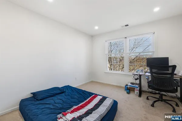 a bedroom with a bed and a chair