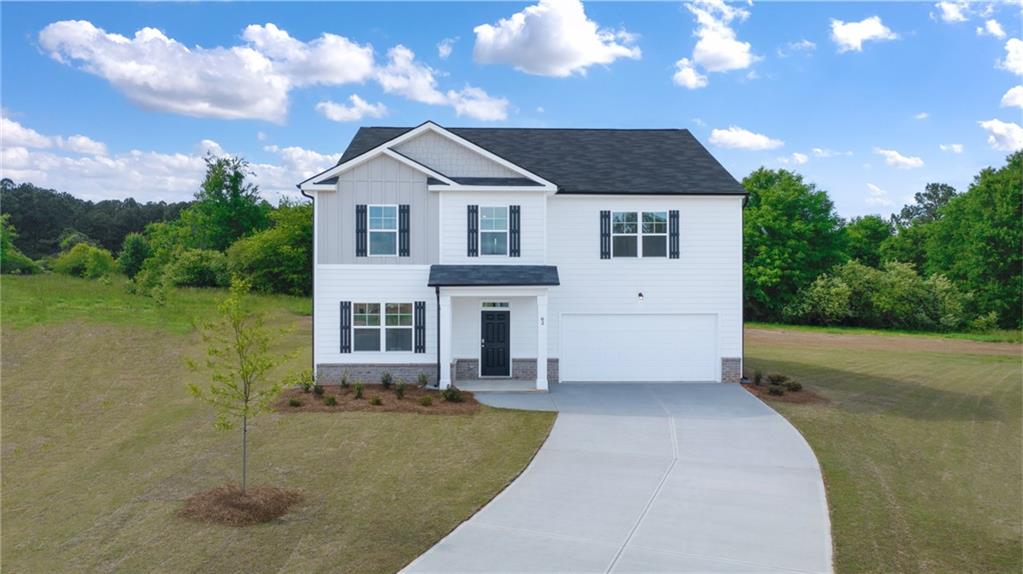 725 Ralph Still Road Dacula, GA 30019 - Photo 1 of 1 a front view of a house with a yard and garage