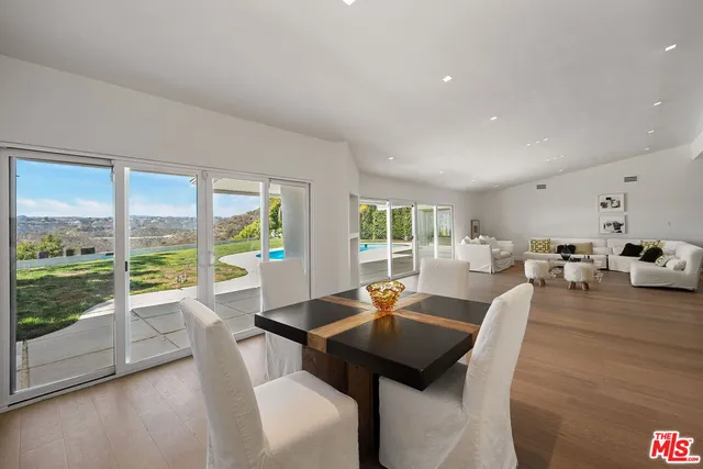 a kitchen with stainless steel appliances granite countertop a refrigerator a sink and wooden cabinets